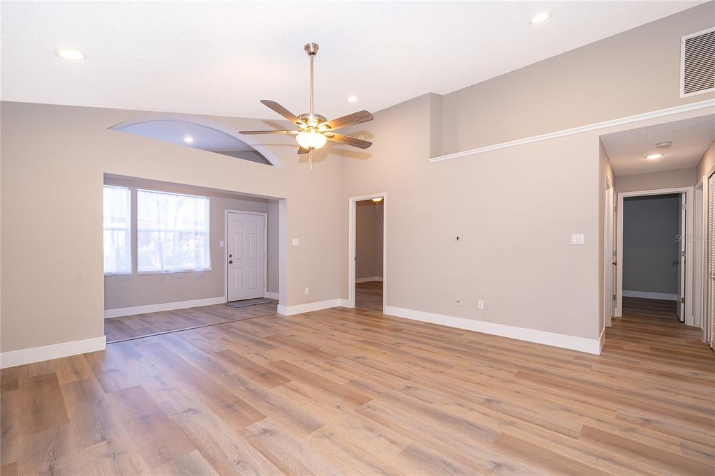 1652 Riveredge Road Oviedo, FL 32766 - Photo 5 of 22 an empty room with wooden floor and ceiling fan