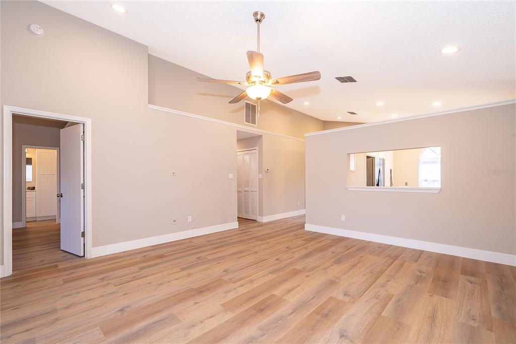1652 Riveredge Road Oviedo, FL 32766 - Photo 6 of 22 a view of an empty room with window and wooden floor