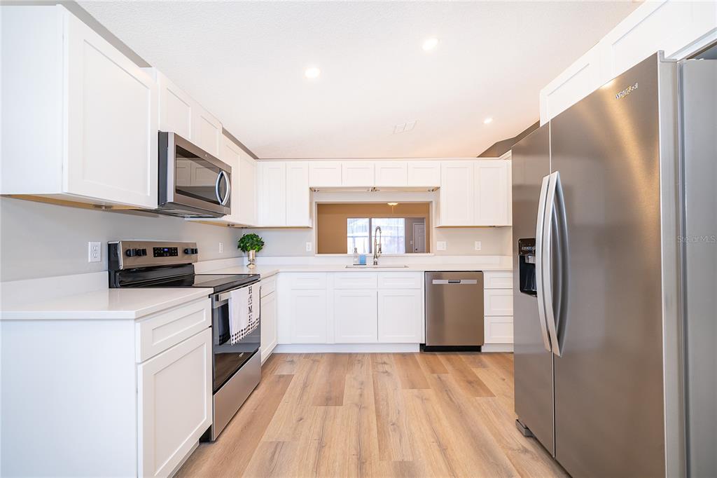 1652 Riveredge Road Oviedo, FL 32766 - Photo 7 of 22 a kitchen with a refrigerator sink and stove top oven