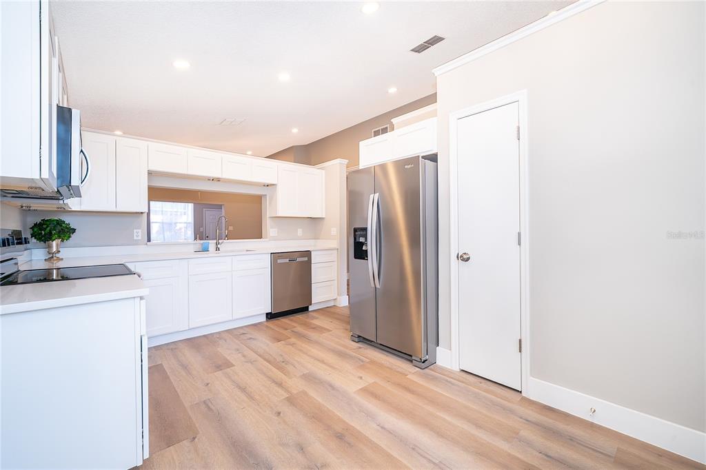 1652 Riveredge Road Oviedo, FL 32766 - Photo 8 of 22 a kitchen with white cabinets and white appliances