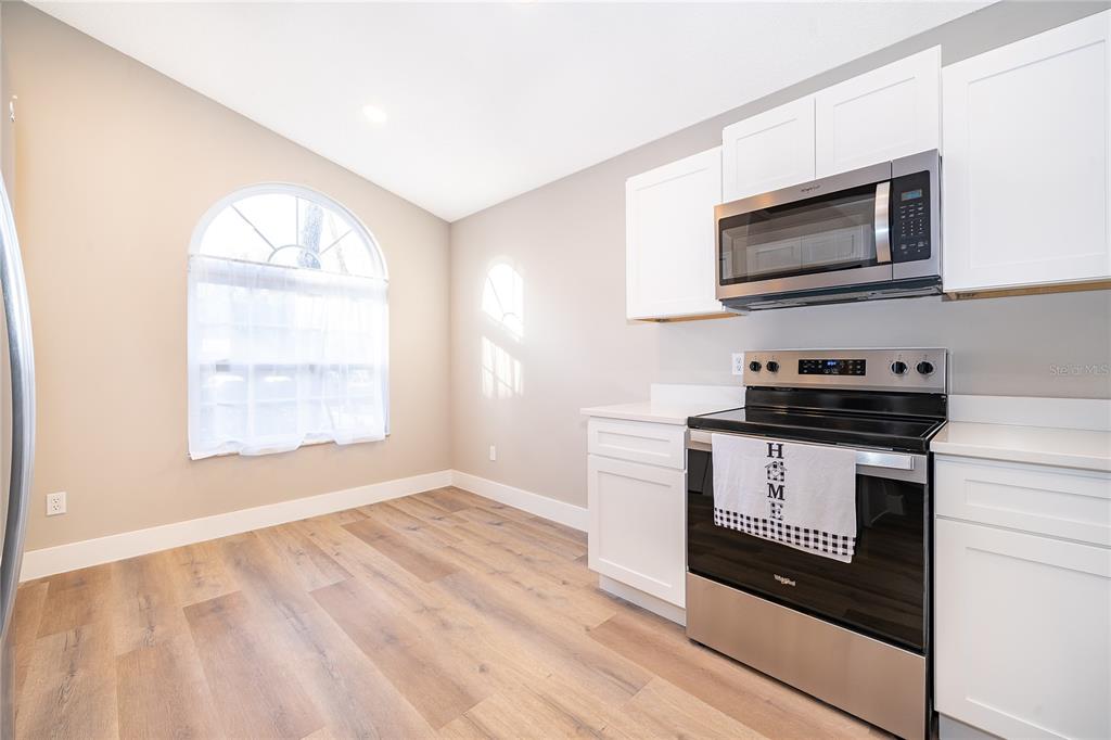 1652 Riveredge Road Oviedo, FL 32766 - Photo 9 of 22 a kitchen with a stove and a microwave