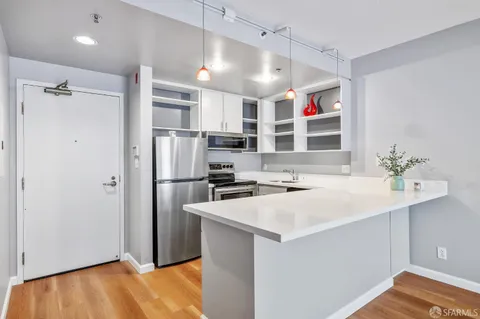 a kitchen with a sink appliances and cabinets