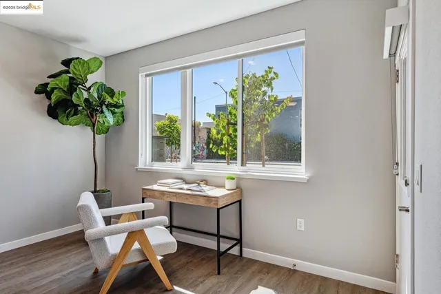 a dining room with furniture potted plants and wooden floor