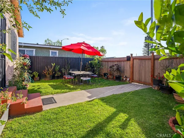 a view of a house with a yard and sitting area
