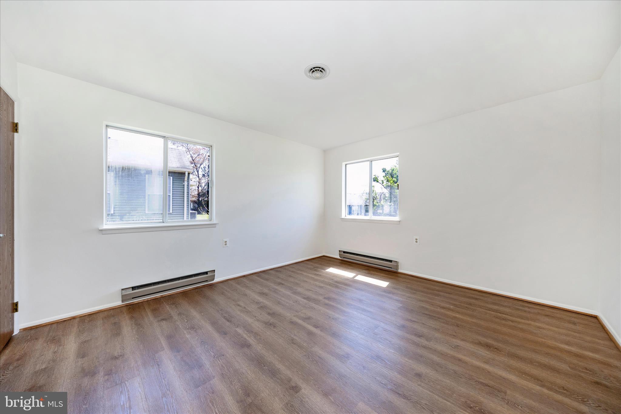 5738 Box Elder Court Frederick, MD 21703 - Photo 20 of 50 an empty room with wooden floor and windows