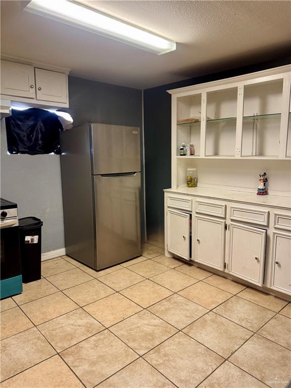 210 West Monte Cristo Road, Unit R Edinburg, TX 78541 - Photo 5 of 18 a kitchen with a refrigerator and cabinets