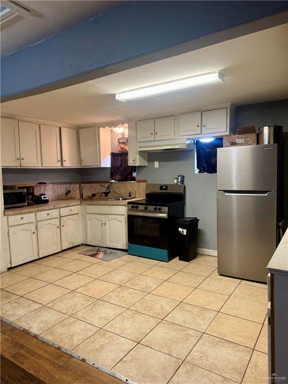 210 West Monte Cristo Road, Unit R Edinburg, TX 78541 - Photo 6 of 18 a kitchen with a cabinets and white stainless steel appliances