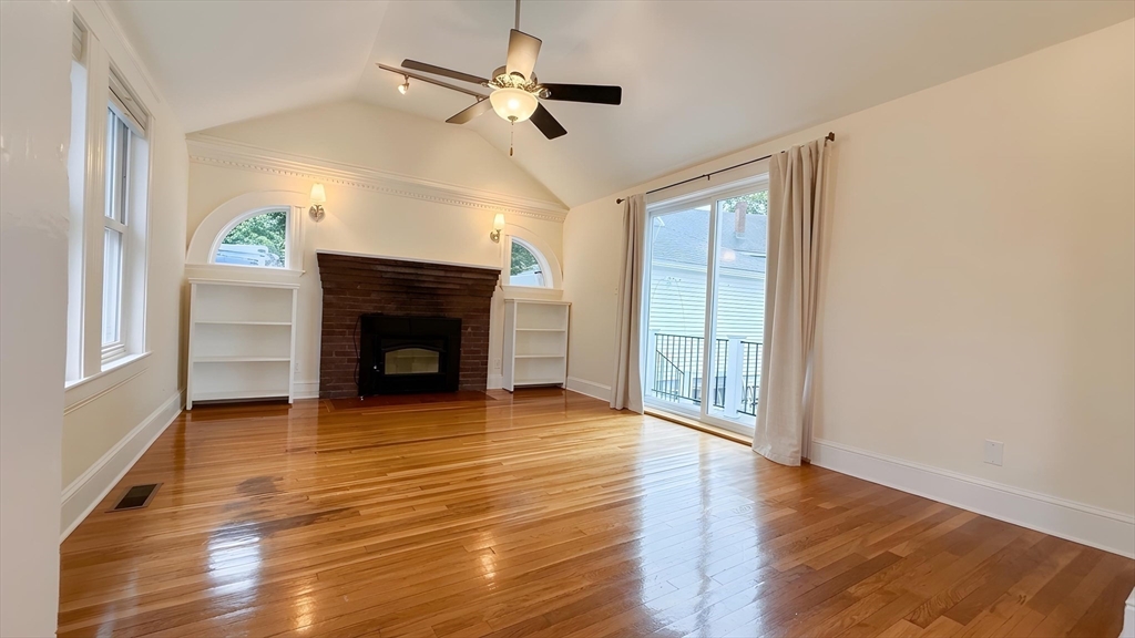 114 Curve Street Dedham, MA 02026 - Photo 4 of 27 wooden floor fireplace and windows in an empty room