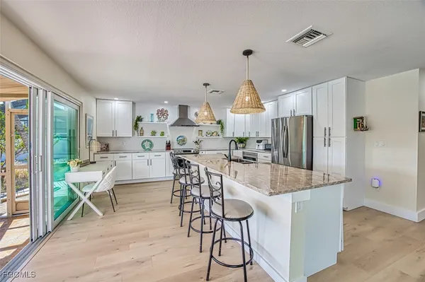 a view of a kitchen with dining table and chairs