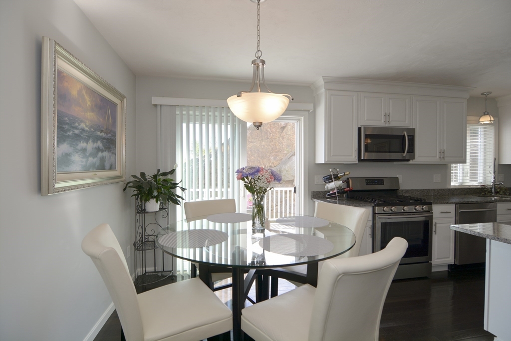 12 Gedney Drive Peabody, MA 01960 - Photo 12 of 41 a dining room with furniture potted plants and wooden floor