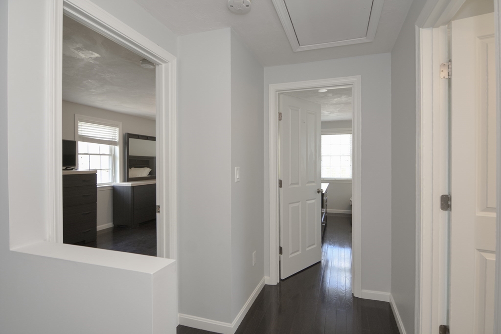 12 Gedney Drive Peabody, MA 01960 - Photo 18 of 41 a view of a hallway with wooden floor and closet