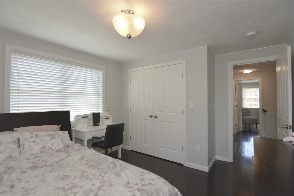 12 Gedney Drive Peabody, MA 01960 - Photo 22 of 41 a bedroom with a bed and a chandelier