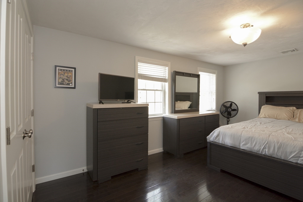12 Gedney Drive Peabody, MA 01960 - Photo 23 of 41 a bedroom with a bed and a flat tv screen on dresser
