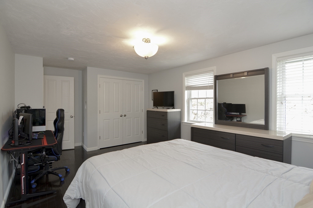 12 Gedney Drive Peabody, MA 01960 - Photo 25 of 41 a bedroom with a bed and a flat screen tv