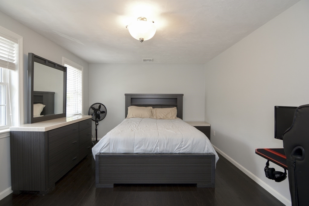 12 Gedney Drive Peabody, MA 01960 - Photo 26 of 41 a bedroom with a bed and a chandelier