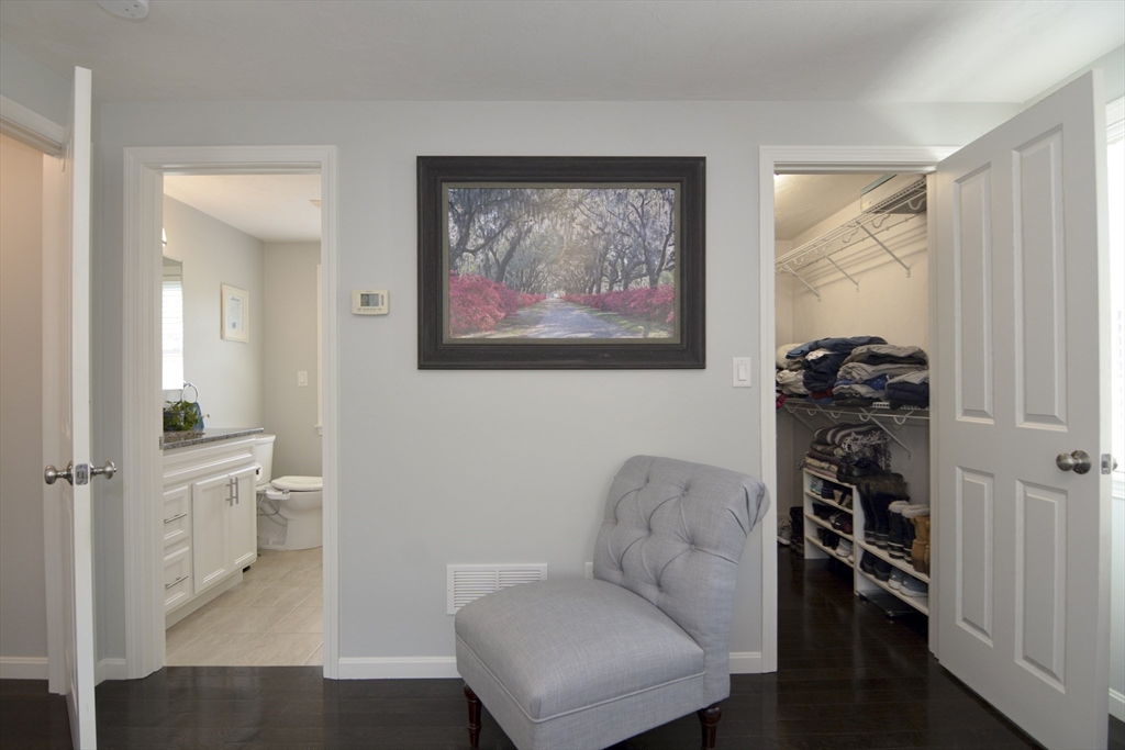 12 Gedney Drive Peabody, MA 01960 - Photo 27 of 41 a hallway with a couch and a painting on the wall