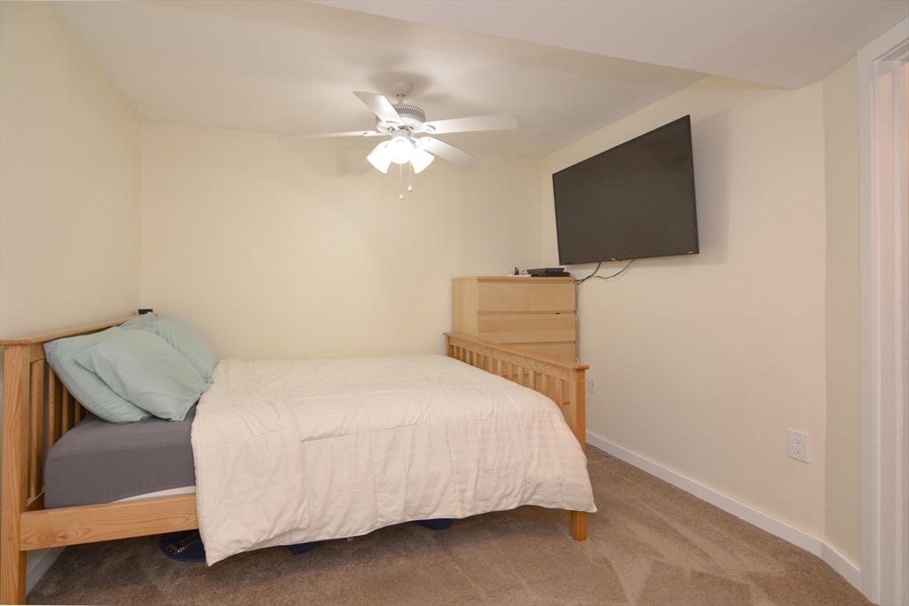 12 Gedney Drive Peabody, MA 01960 - Photo 29 of 41 a bedroom with a bed and a flat screen tv
