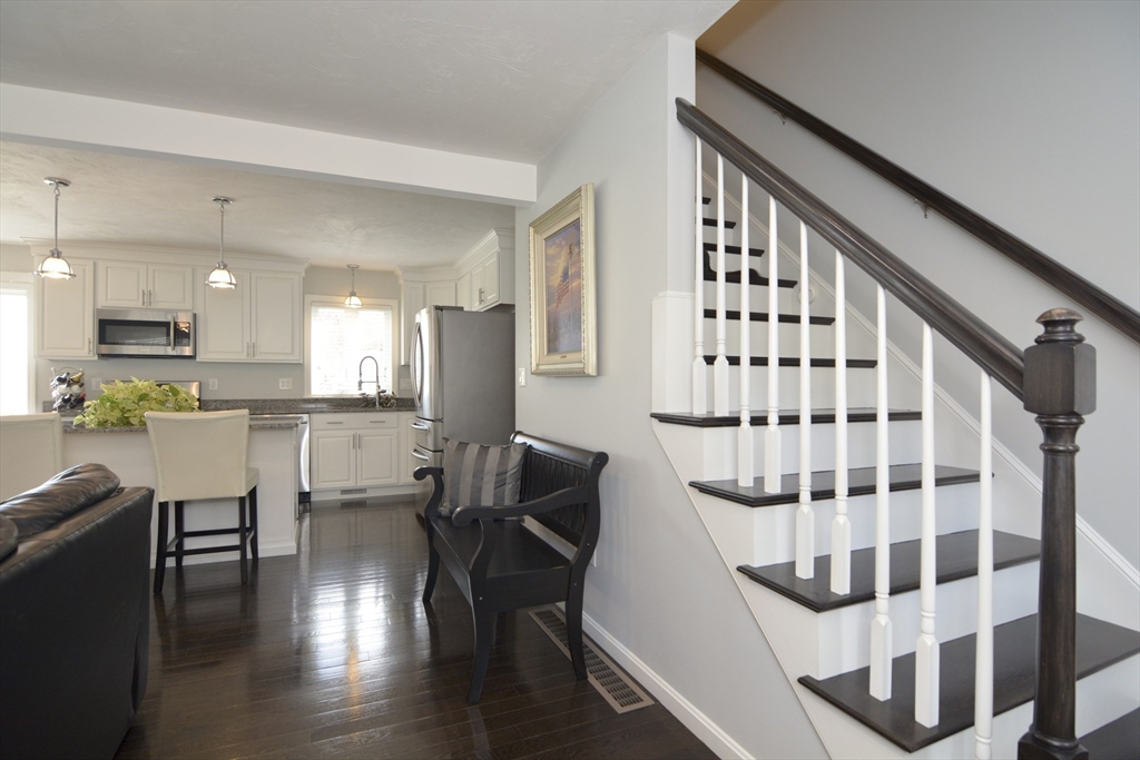 12 Gedney Drive Peabody, MA 01960 - Photo 3 of 41 a kitchen with white cabinets and black stainless steel appliances