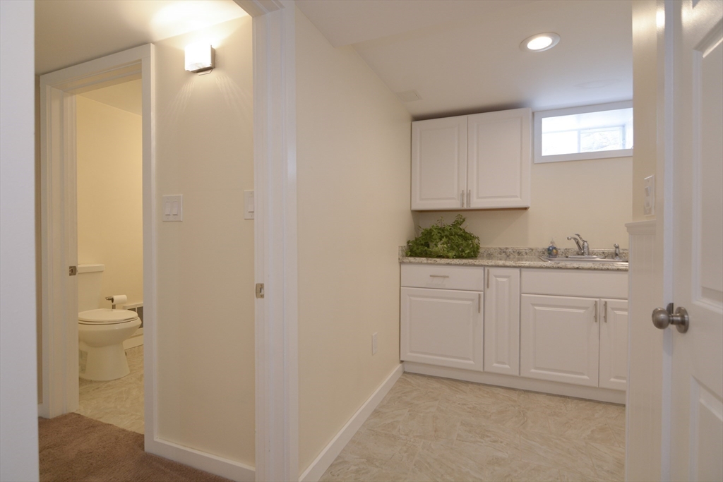 12 Gedney Drive Peabody, MA 01960 - Photo 31 of 41 a bathroom with a granite countertop sink and a toilet