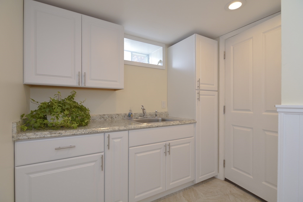 12 Gedney Drive Peabody, MA 01960 - Photo 32 of 41 a bathroom with a sink and cabinets