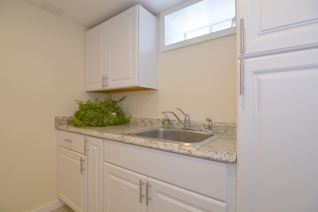 12 Gedney Drive Peabody, MA 01960 - Photo 33 of 41 a kitchen with granite countertop a sink and cabinets