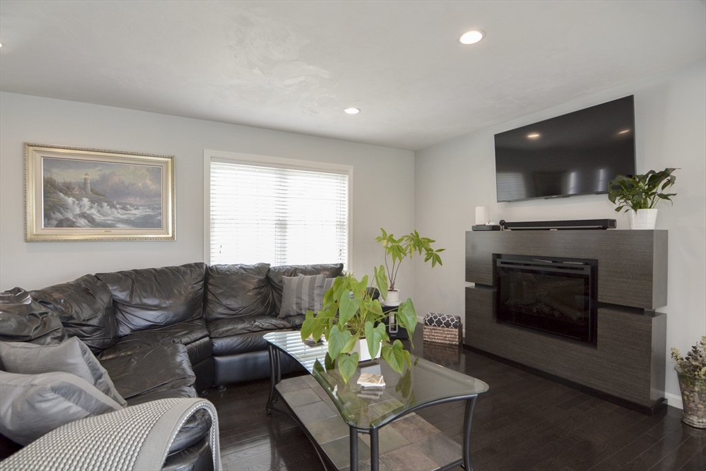 12 Gedney Drive Peabody, MA 01960 - Photo 4 of 41 a living room with furniture a flat screen tv and a fireplace