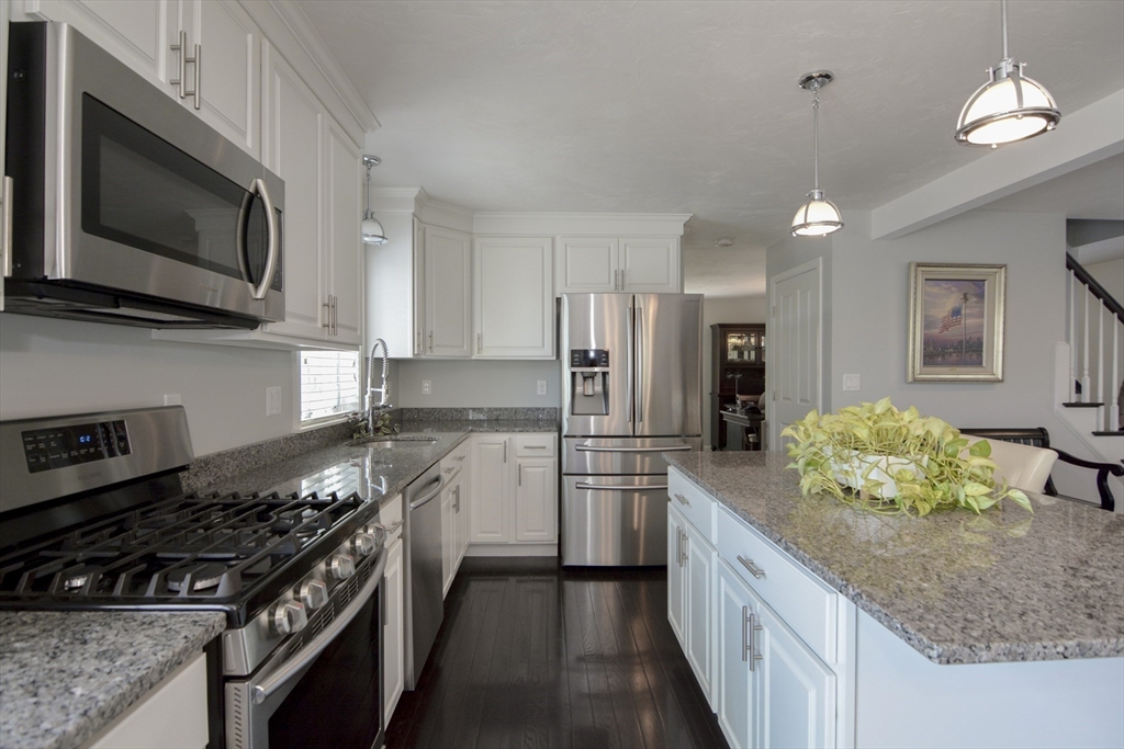 12 Gedney Drive Peabody, MA 01960 - Photo 6 of 41 a kitchen with stainless steel appliances kitchen island granite countertop a stove a sink and a microwave