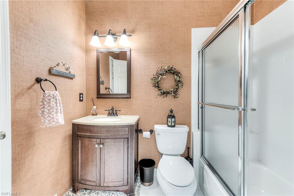 8471 Southbridge Drive, Unit 1 Estero, FL 33967 - Photo 19 of 37 a bathroom with a toilet sink and mirror