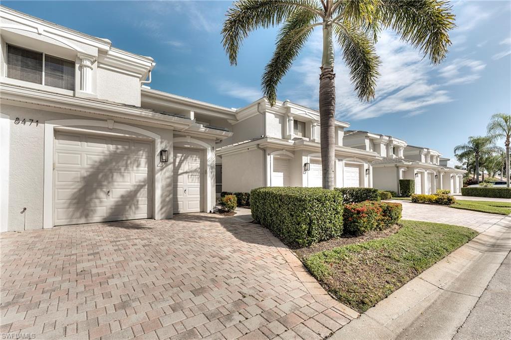 8471 Southbridge Drive, Unit 1 Estero, FL 33967 - Photo 2 of 37 a front view of a house with a garden