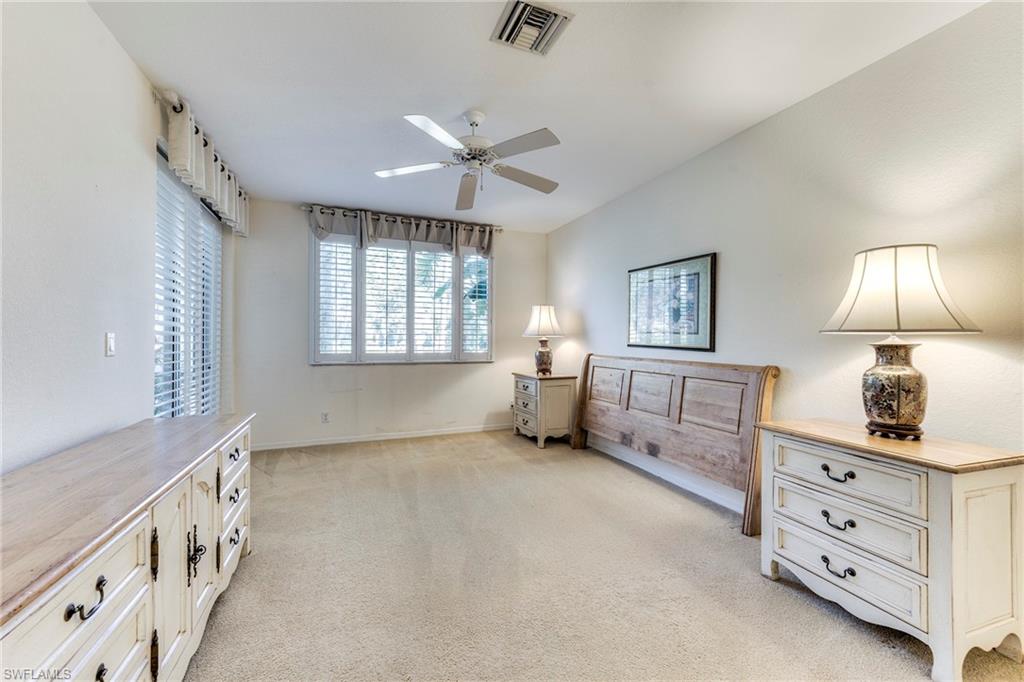 8471 Southbridge Drive, Unit 1 Estero, FL 33967 - Photo 21 of 37 a spacious bedroom with furniture and a window