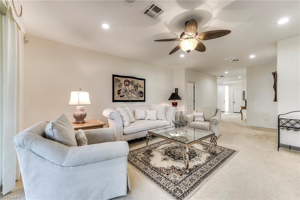 8471 Southbridge Drive, Unit 1 Estero, FL 33967 - Photo 10 of 37 a living room with furniture and a chandelier