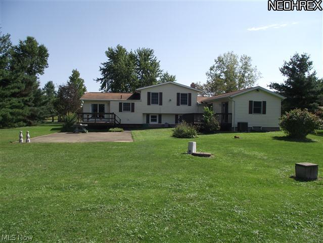 Back of home shows the 2 decks that lead into the home via french doors.  A large cement patio, and large private back yard makes this home great for entertainig or just enjoyings the outside.