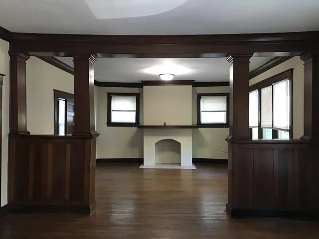 a view of a room with wooden floor and windows