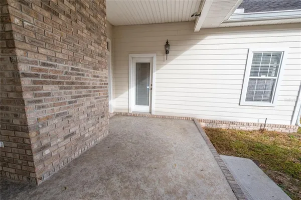 an aerial view of a house with a yard and outdoor seating