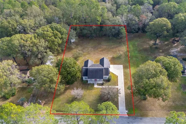 an aerial view of house with yard