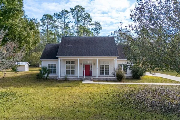 a view of a house with a yard