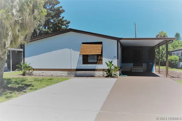 a front view of a house with a yard and a garage