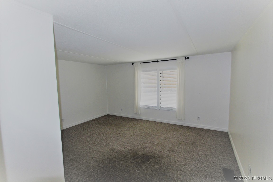 105 Oak Street Edgewater, FL 32141 - Photo 12 of 29 an empty room with a empty space and windows