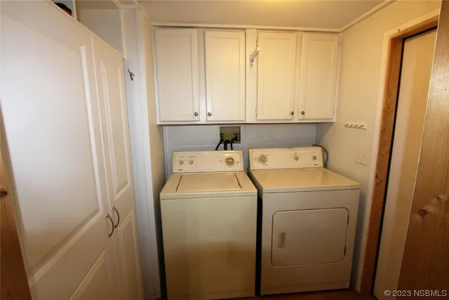 a view of storage and utility room with washer and dryer