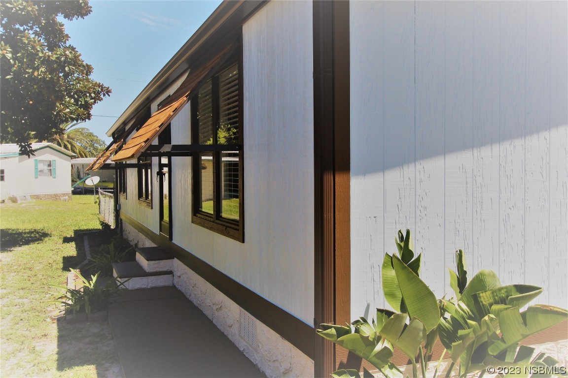 105 Oak Street Edgewater, FL 32141 - Photo 18 of 29 a balcony with couple of flower plants and wooden fence