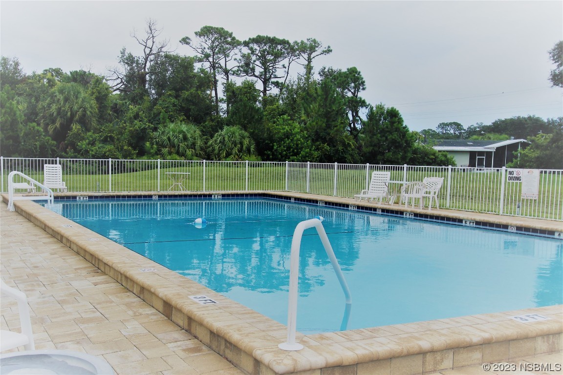 105 Oak Street Edgewater, FL 32141 - Photo 22 of 29 a view of a swimming pool with a yard