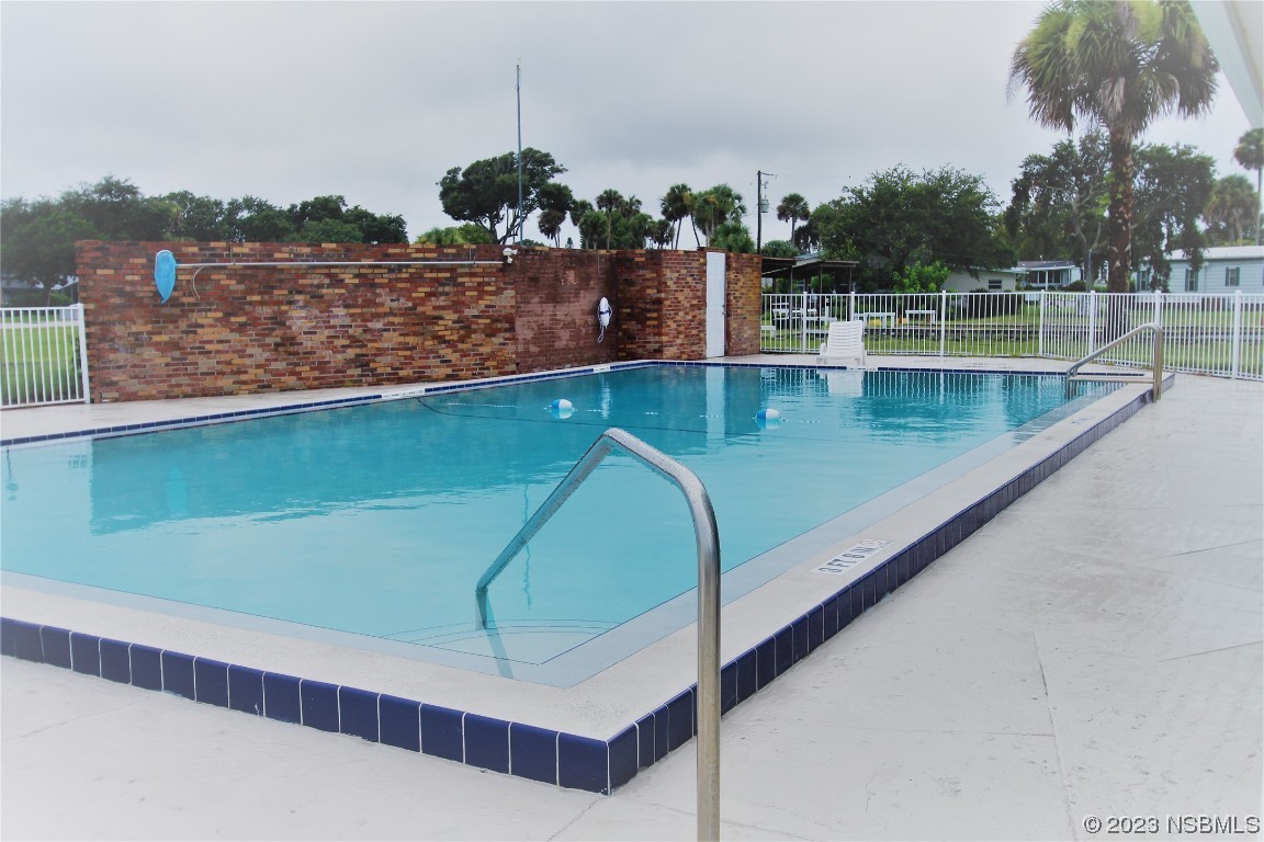 105 Oak Street Edgewater, FL 32141 - Photo 25 of 29 a view of a swimming pool with a lake view