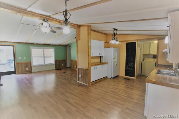 a view of a kitchen with a sink and a refrigerator