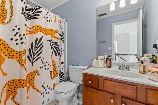 a bathroom with a sink mirror vanity and toilet