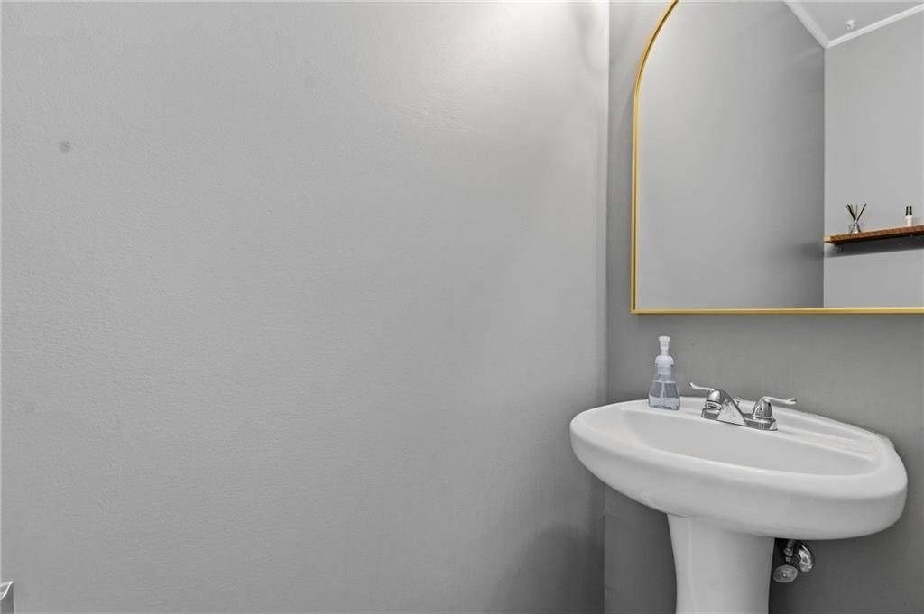 293 Jordan Street Southeast Atlanta, GA 30315 - Photo 16 of 26 a bathroom with a sink and a mirror