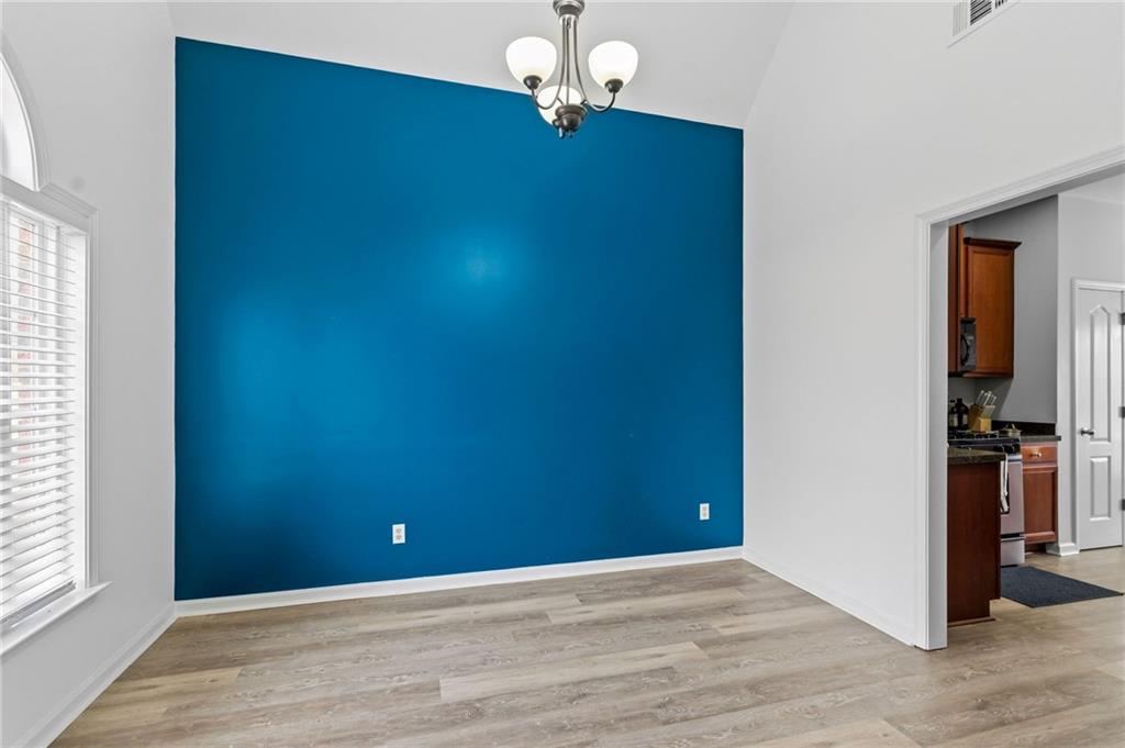 293 Jordan Street Southeast Atlanta, GA 30315 - Photo 18 of 26 wooden floor in an empty room with a window