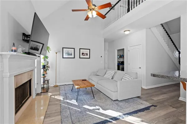 a living room with furniture a fireplace and a flat screen tv