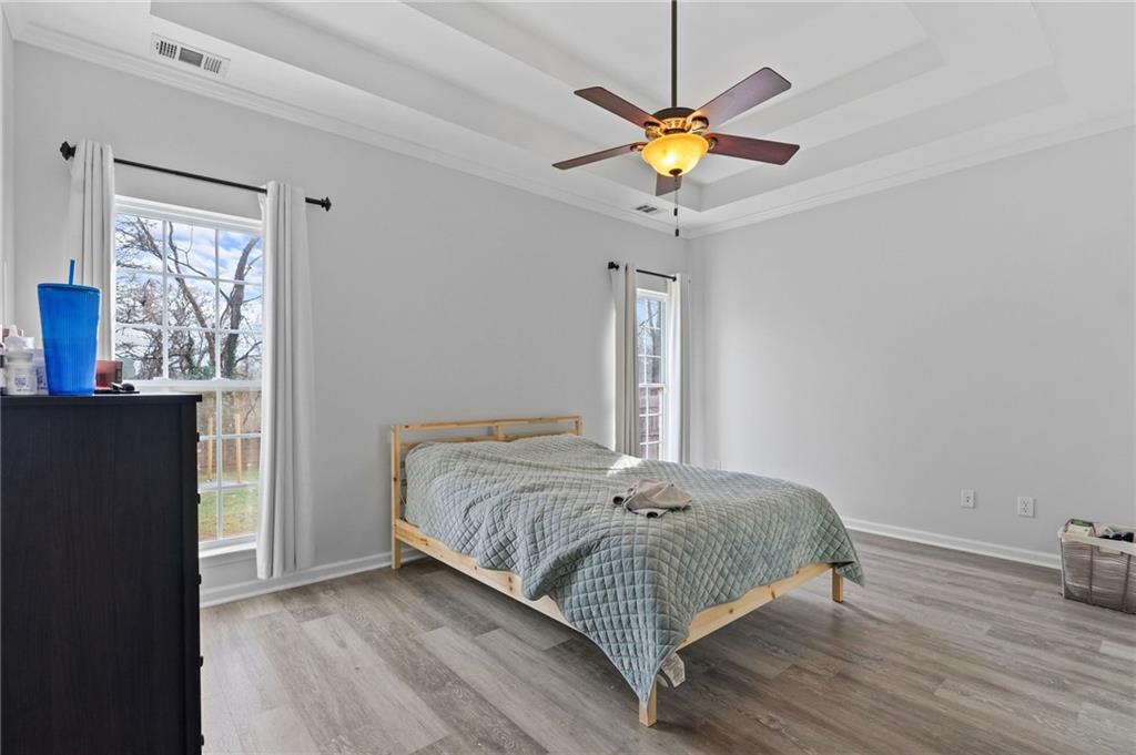 293 Jordan Street Southeast Atlanta, GA 30315 - Photo 23 of 26 a bedroom with a bed and a chandelier