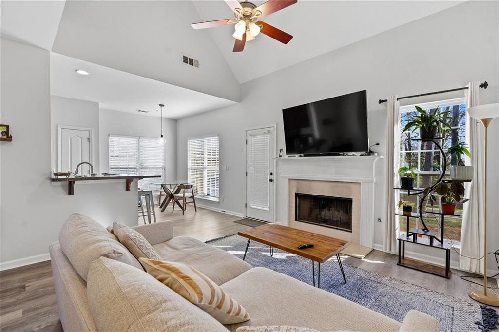 293 Jordan Street Southeast Atlanta, GA 30315 - Photo 4 of 26 a living room with furniture a flat screen tv and a fireplace