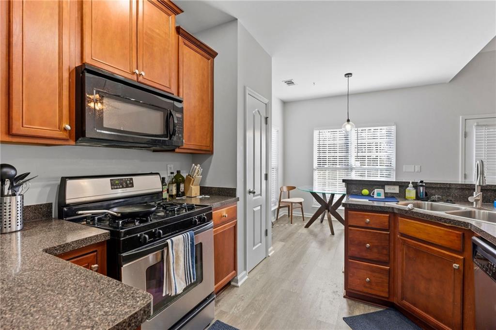 293 Jordan Street Southeast Atlanta, GA 30315 - Photo 7 of 26 a kitchen with stainless steel appliances granite countertop a stove a sink and a microwave